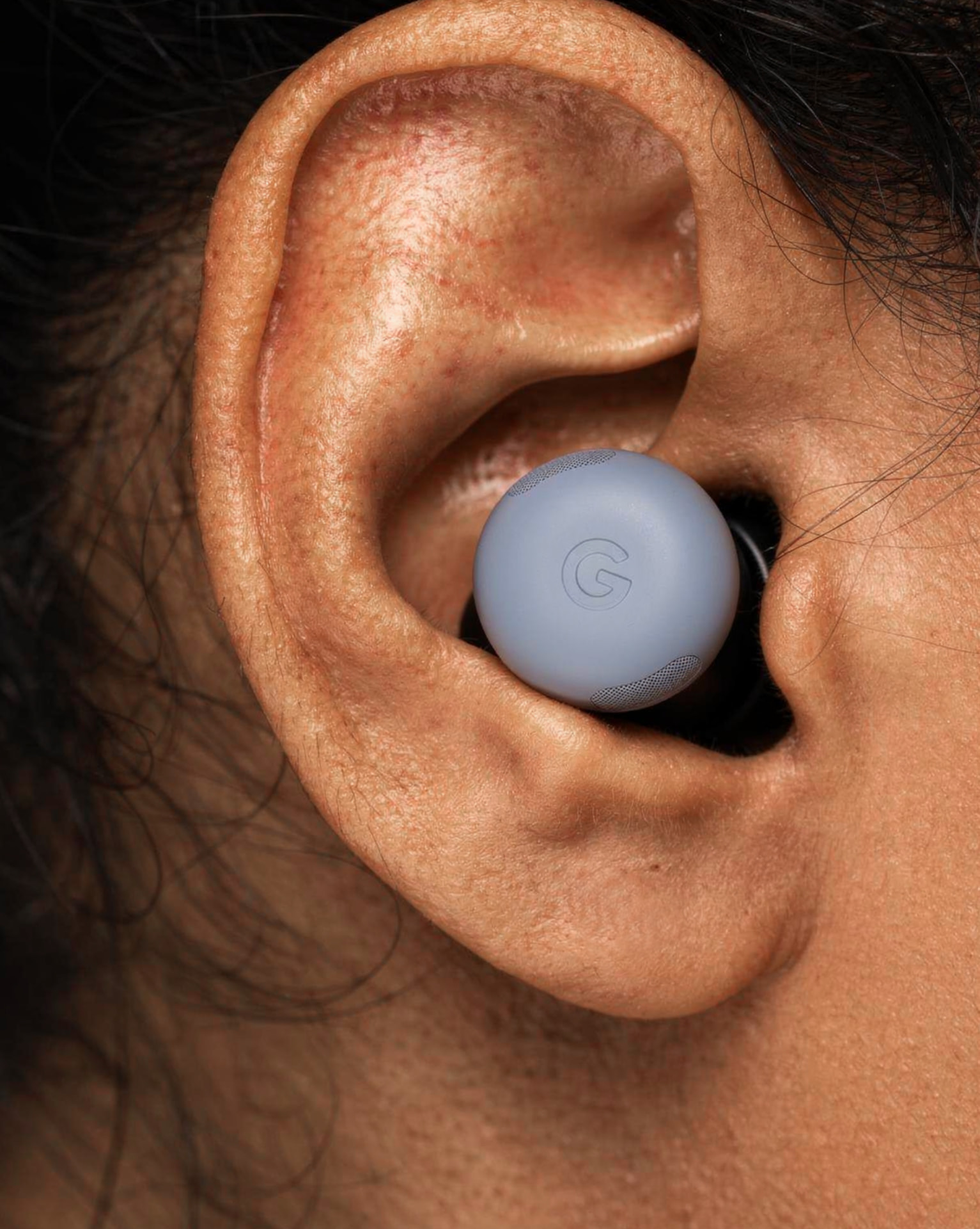 Close-up of an earbud placed in an ear