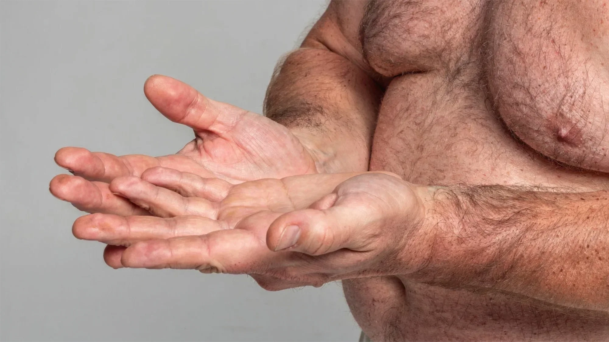 AI-generated close view of two open, empty hands held out in front of a bare chest